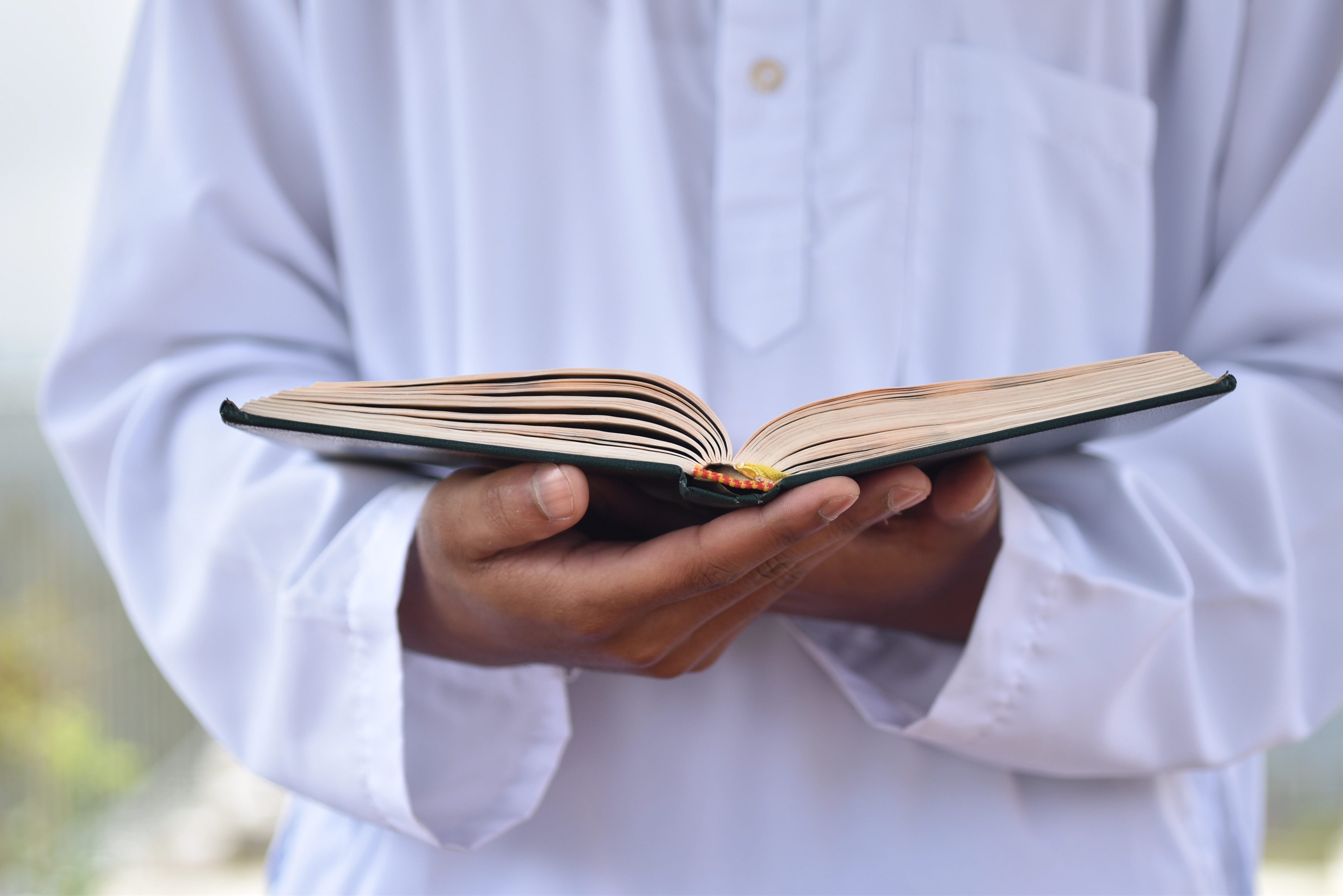Holy Quran with Tajweed held in hand