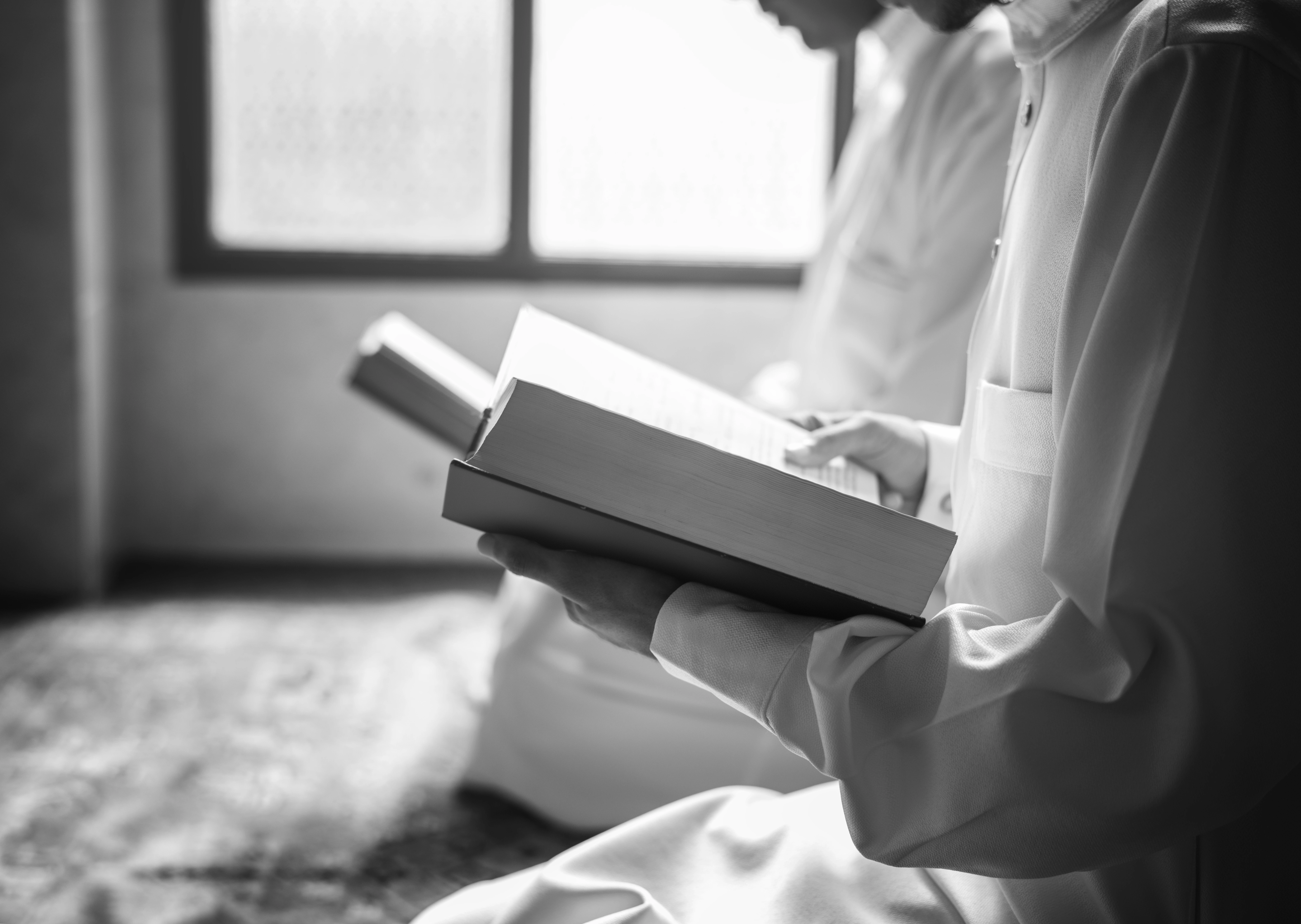 Muslims reading Quran at a Masjid